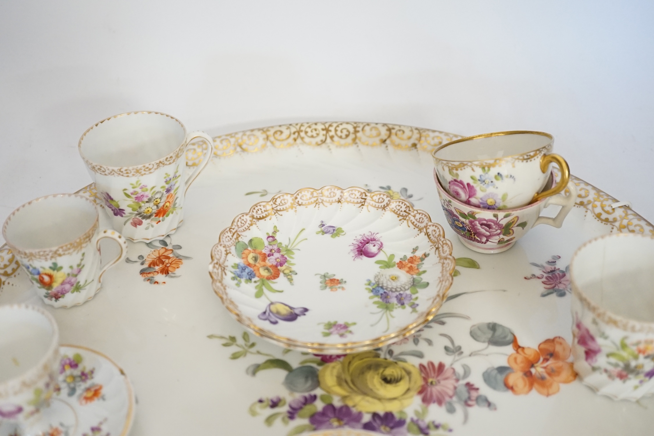 A Dresden floral painted tray and other coffee wares, 39cm diameter. Condition - poor to fair
